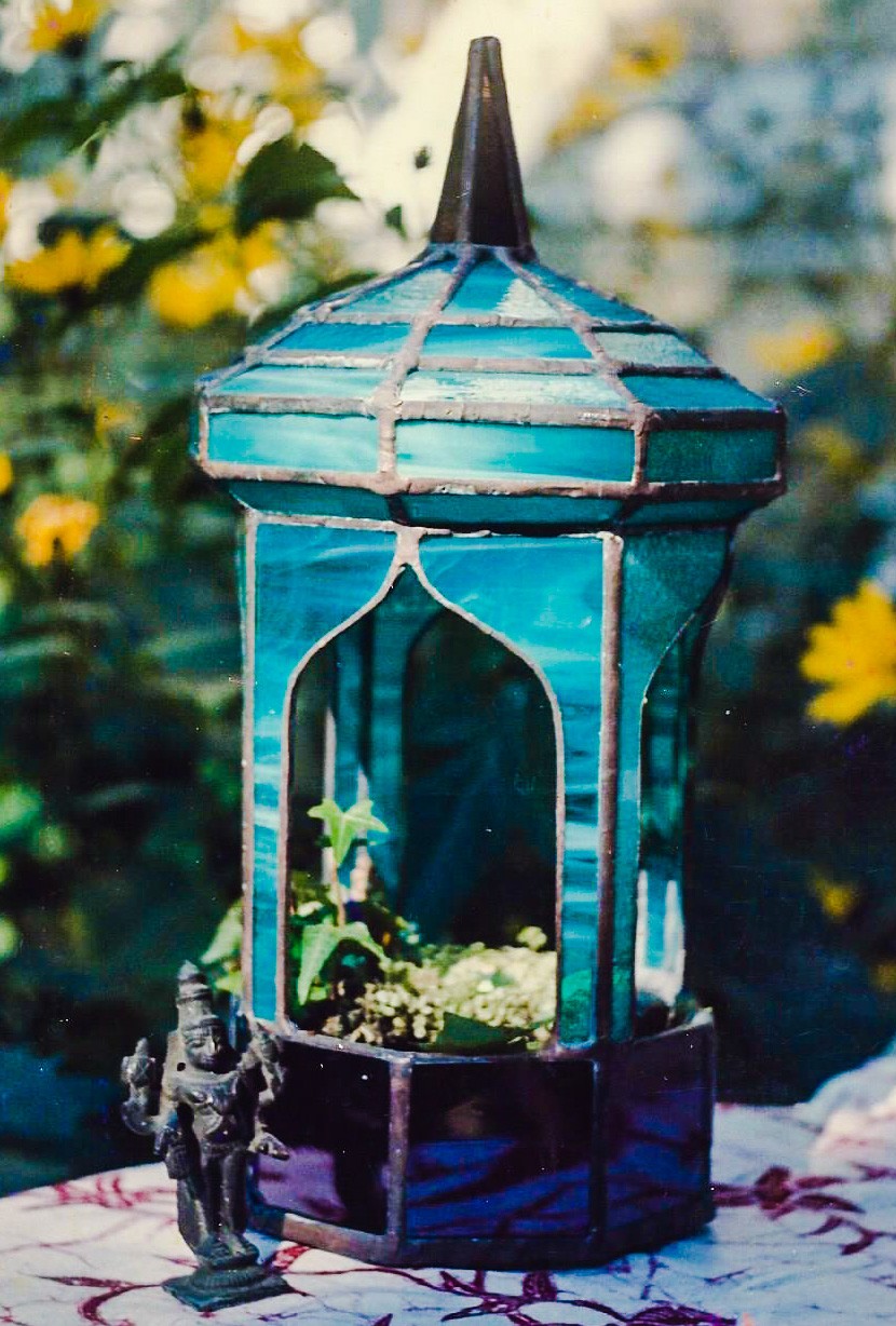 Close-up of green minaret style stained glass terrarium.