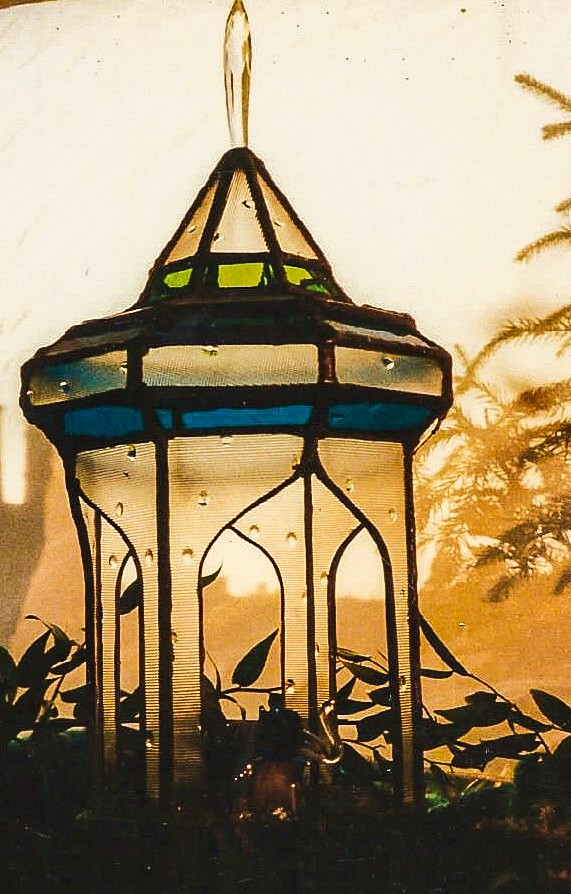 Close-up of blue/green minaret style stained glass terrarium.