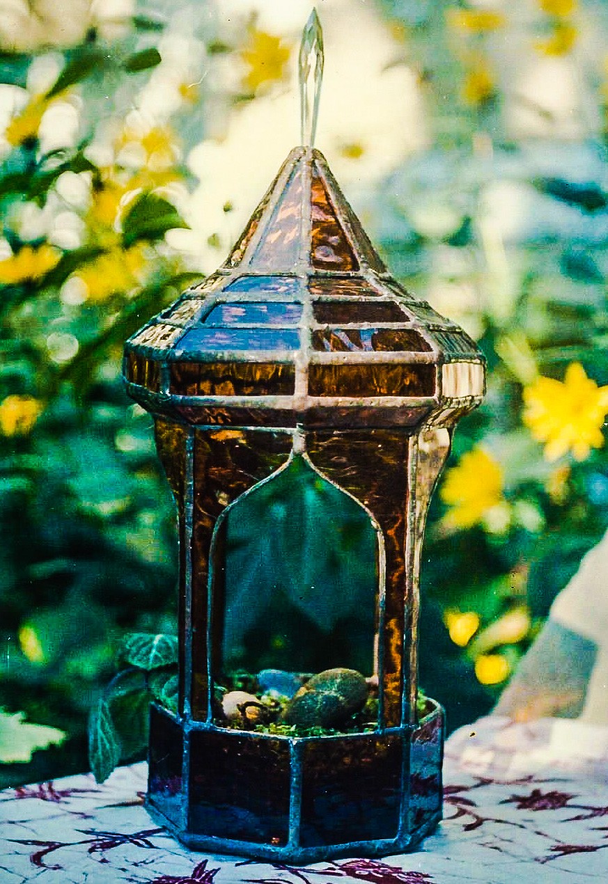 Close-up of amber minaret style stained glass terrarium.