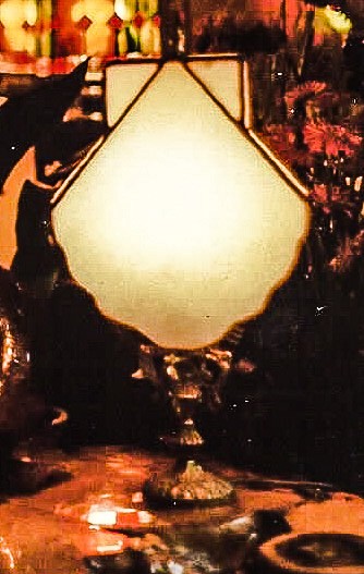 White seashell shaped stained glass lampshade.