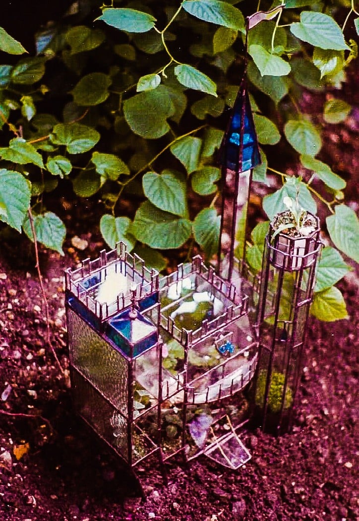 Ariel view of multi-tiered castle shaped stained glass terrarium.